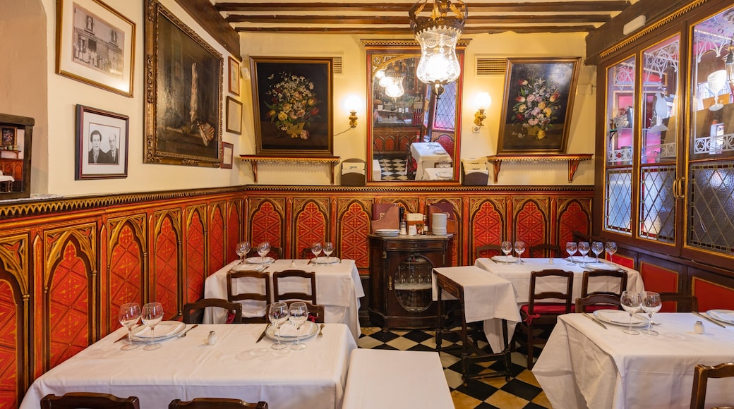 Candlelit dining room at Botín with red Gothic paneling