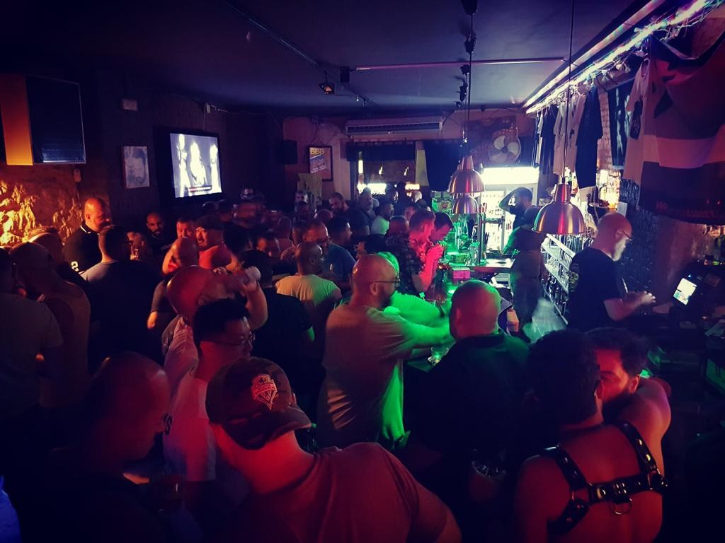 Crowd of men at the bar, Bacon Bear Bar