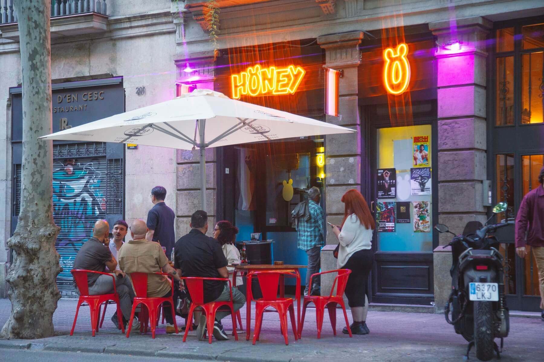 Terrace with red chairs at Honey bar