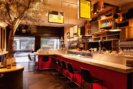Tapas bar counter inside Mercado de la Reina 12