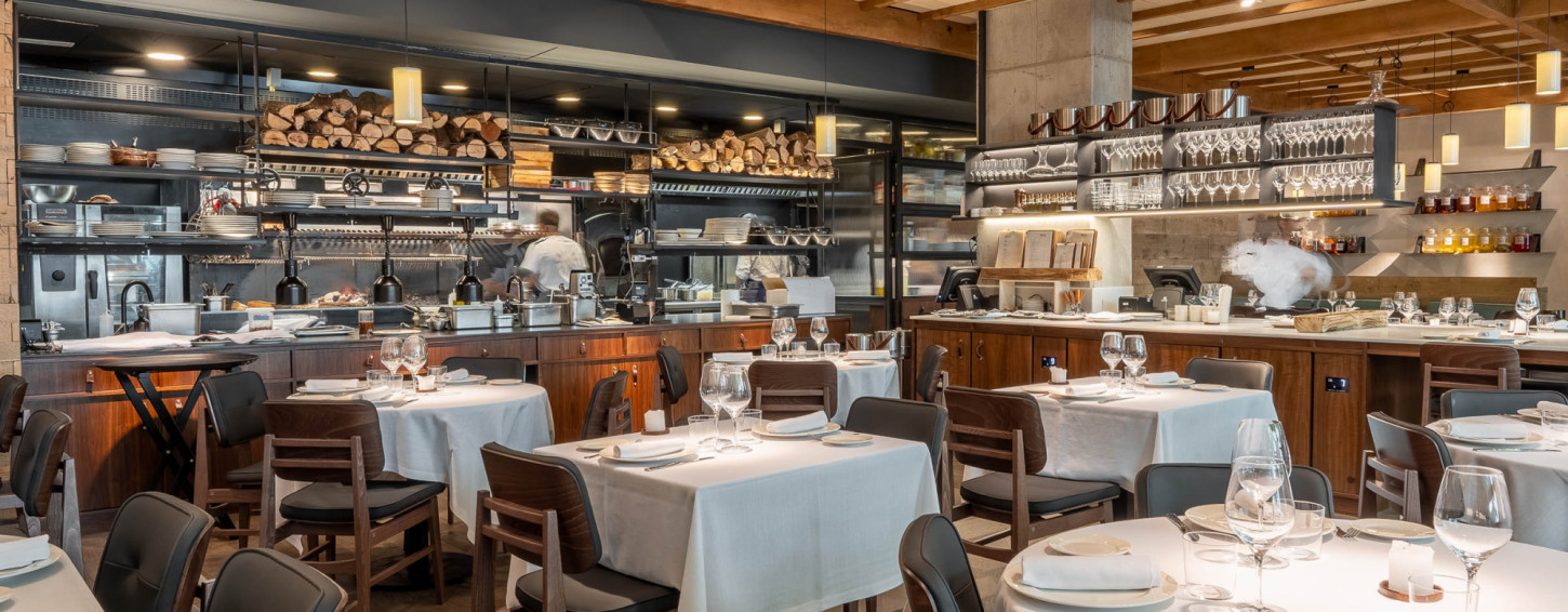 Open kitchen with firewood stacks at Molino de Pez