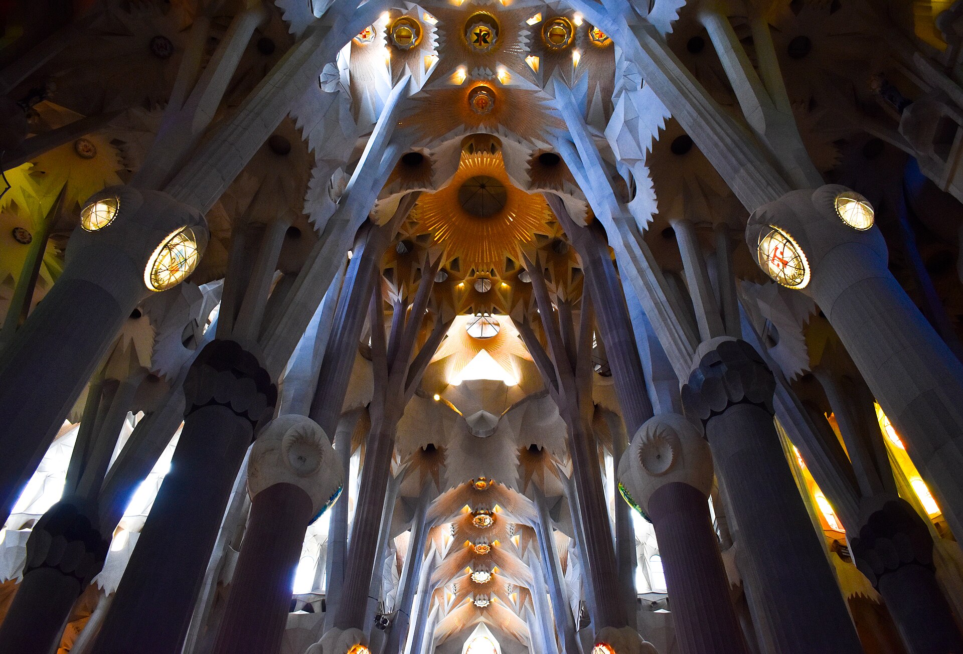 Inside the Sagrada Família nave, looking up at the branching columns and vault
